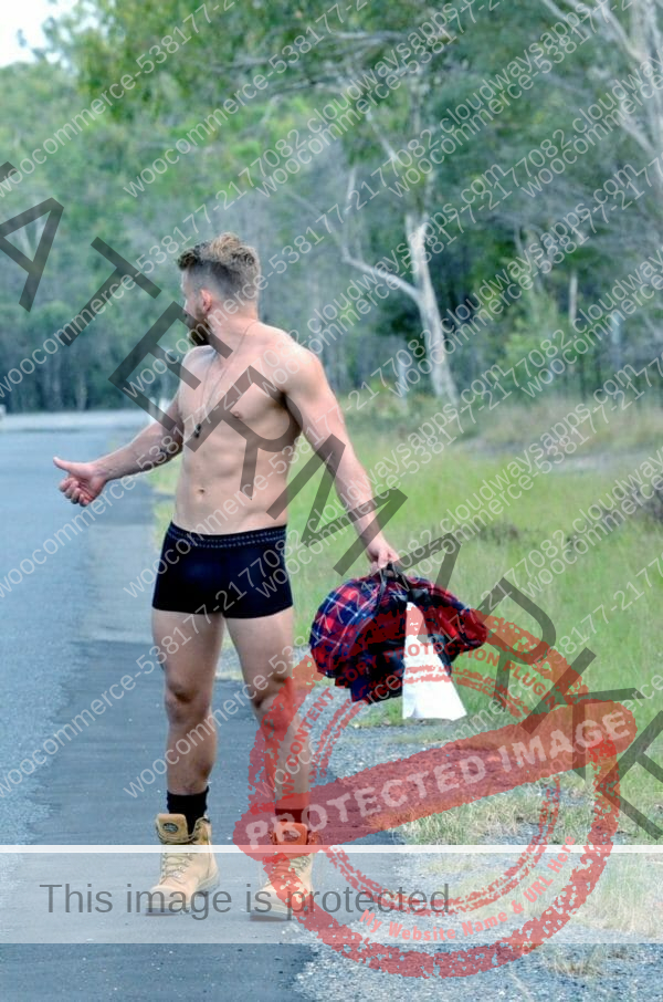 This is a photograph of a male model hitchhiking while only wearing a pair of black Bamboo Men's Trunks, available from Bamboo Creations Victoria